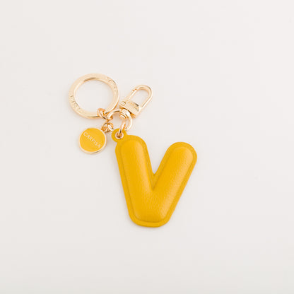 Llavero para mujer - llavero con letras bombardeadas Mostaza